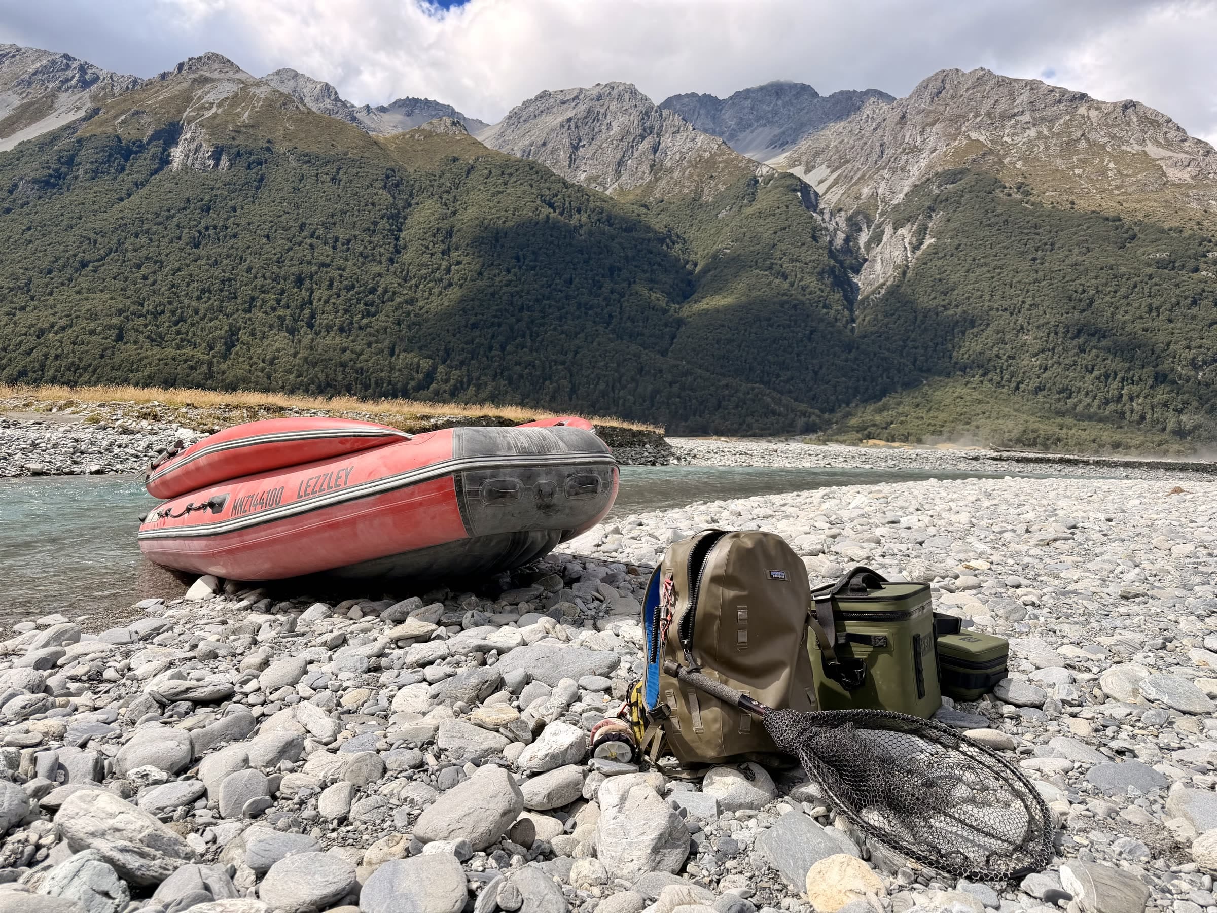 The SIB River Jet Lux beached on a remote South Island riverbed with fishing gear